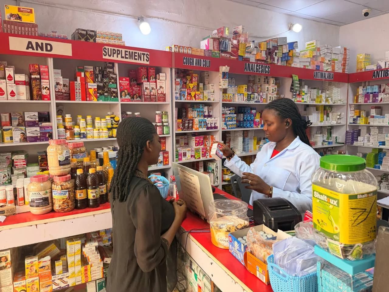 Pharmacist counselling a customer at a Janora Pharmacy counter