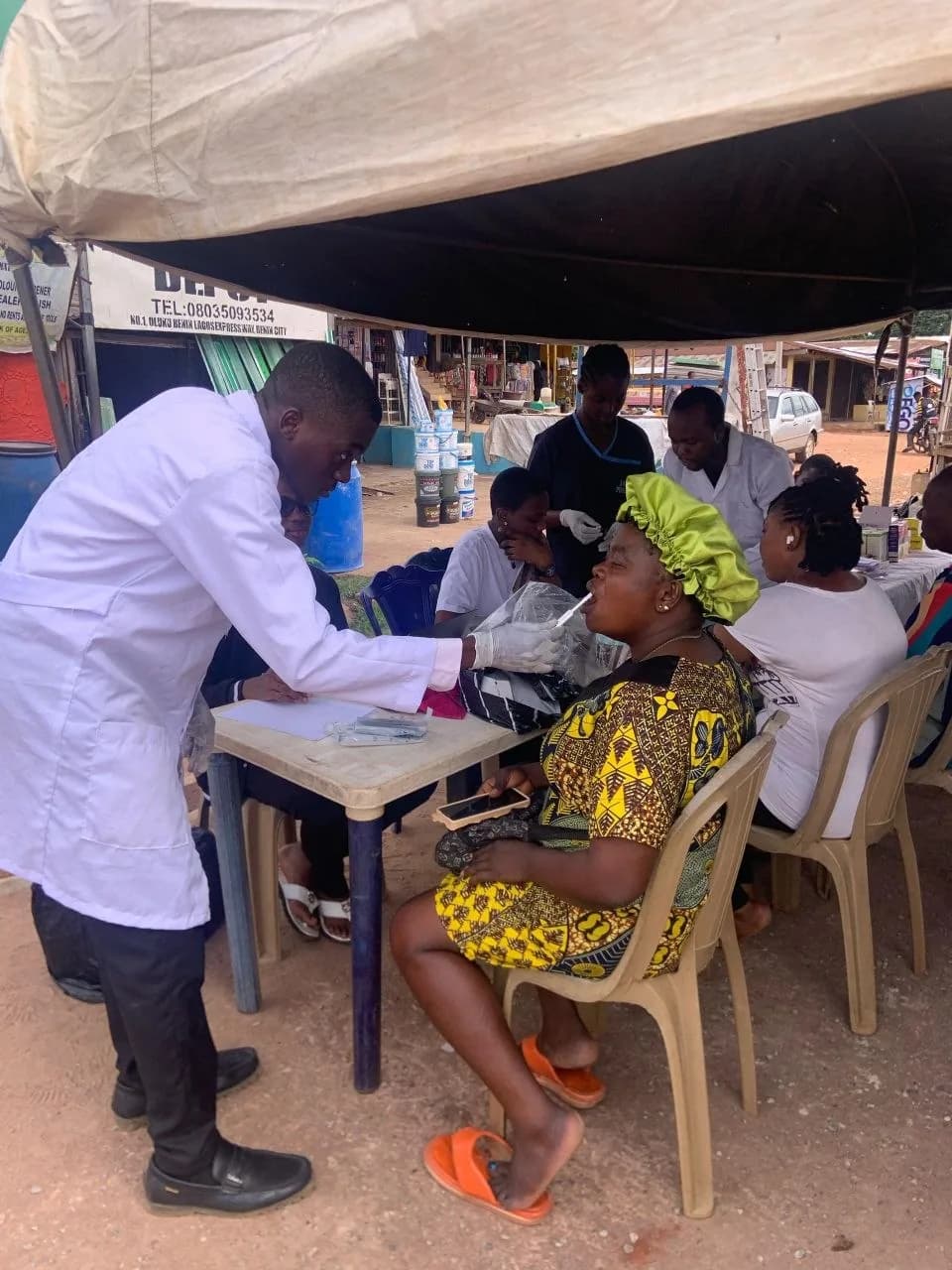 A pharmacist conducting a check-up on a patient at the outreach