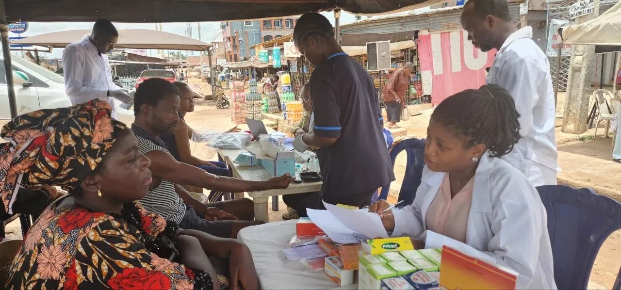 Pharmacists consulting with patients at a dispensing table